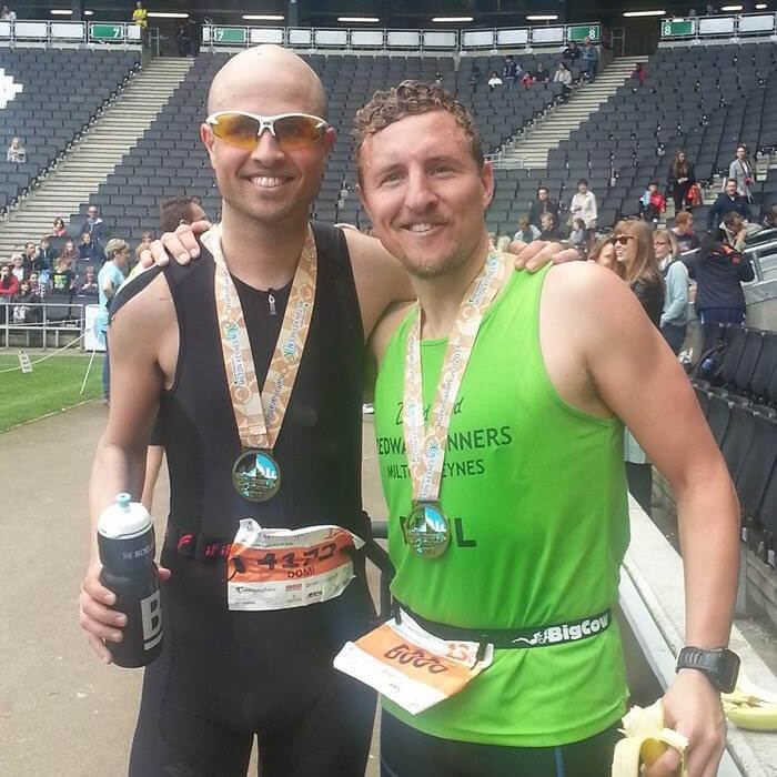 Domenico Buonocore and his friend wearing medals in a stadium smiling